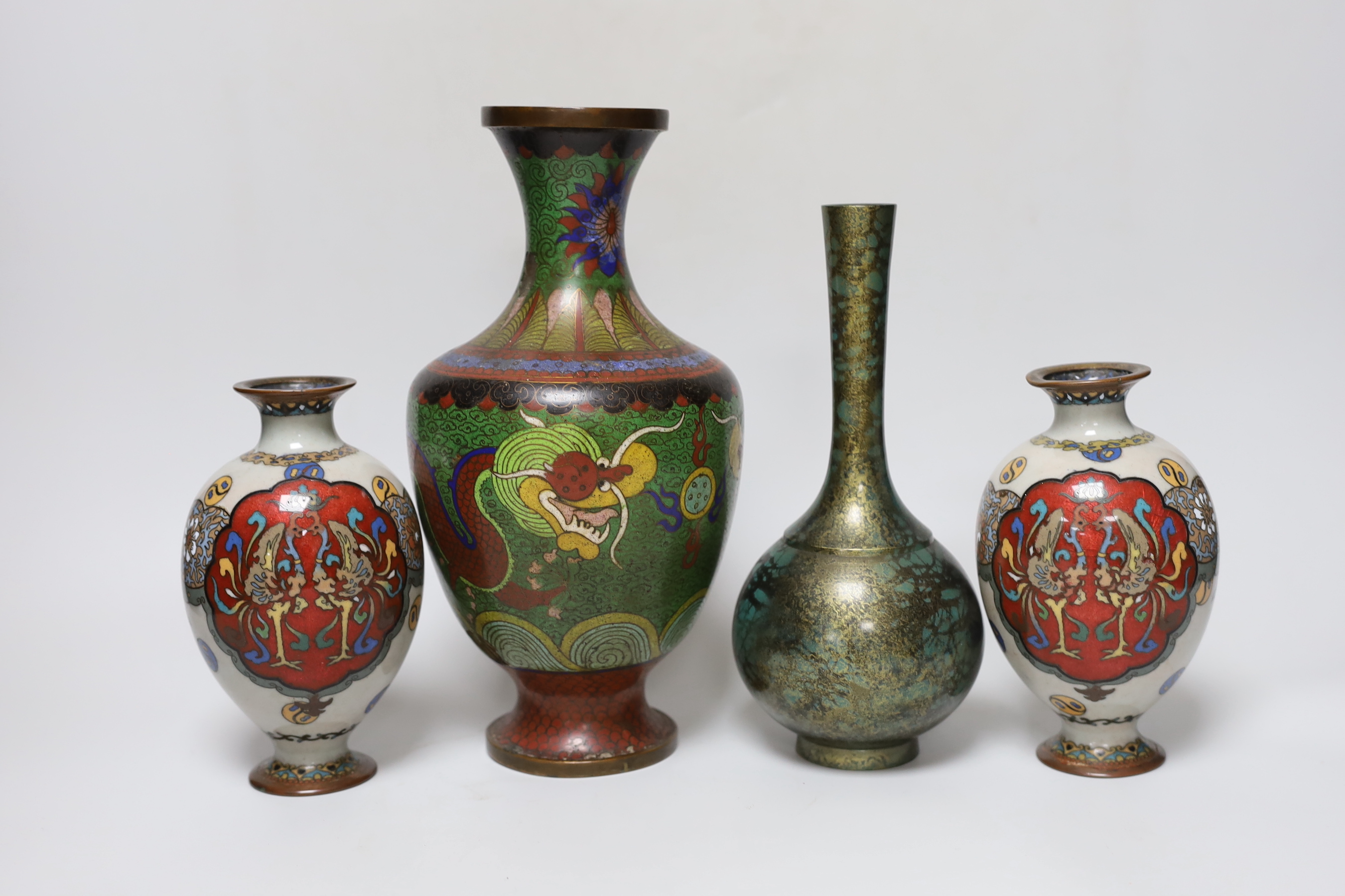 A pair of Japanese cloisonné enamel vases, a Chinese cloisonné enamel vase and a signed mottled bronze bottle vase, tallest 26cm